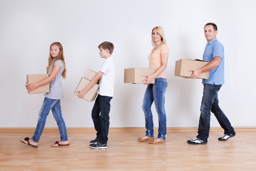 Local removals team handling furniture in a Shoreditch apartment move